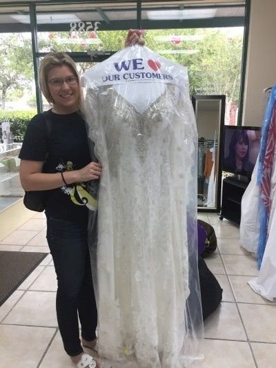 Bride Inspecting the gown after cleaning