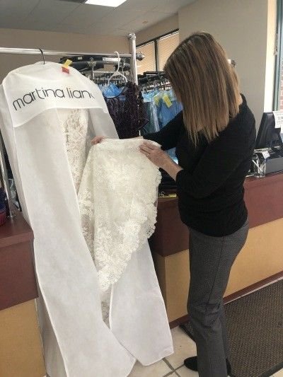 Bride Inspecting the gown after cleaning